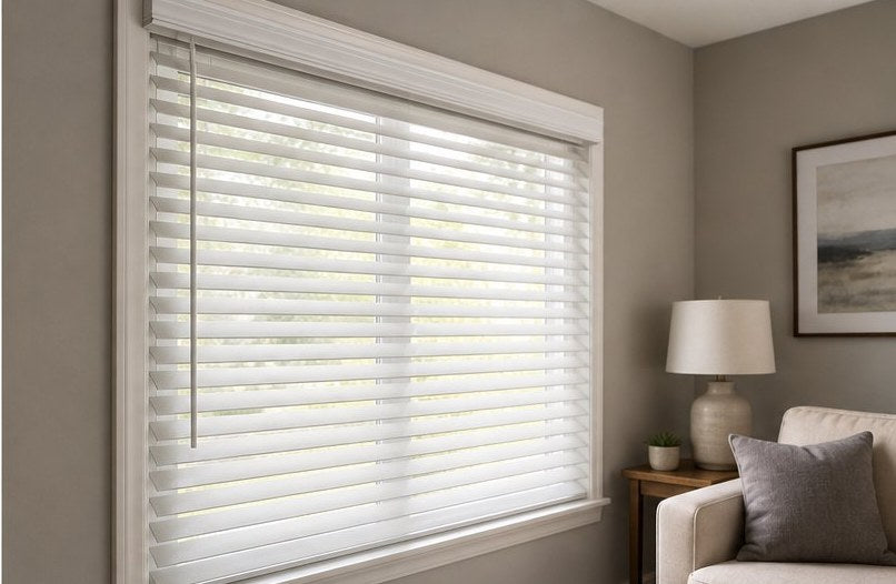 White 2-inch faux wood blinds in a styled living-room window
